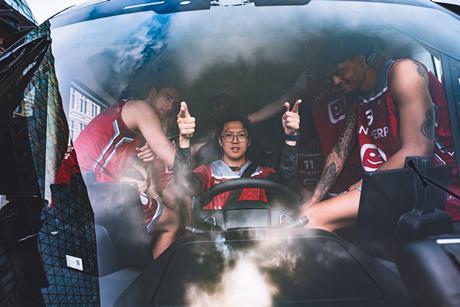 Windrose CEO Wen Han with basketball team Antwerp Giants inside the cab of the Windrose truck